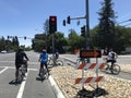 Several adult bicyclists wait for green light