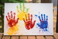 several adult handprints on a family canvas