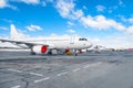 Several aircraft parked at the airport in good weather.