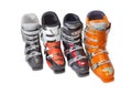 Several alpine ski boots on a light background