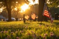 Several American flags placed in the grass at sunset, creating a patriotic scene, A tranquil early morning scene at a military Royalty Free Stock Photo