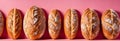 several baguets of various types on a pink background Royalty Free Stock Photo