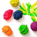 Several balls of multicolored plasticine on the white background.