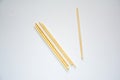 On a pure white background, several bamboo chopsticks are scattered, showcasing a simple and natural state Royalty Free Stock Photo