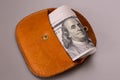 Several banknotes cute looks out of brown leather retro purse