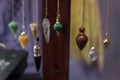 Several Beautiful Crystal Pendulums Hanging on Display