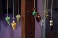 Several Beautiful Crystal Pendulums Hanging on Display