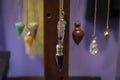 Several Beautiful Crystal Pendulums Hanging on Display