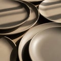 Diagonal shadows across the plates, enhancing their smooth texture and Royalty Free Stock Photo