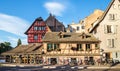 Several bicycles are located along the old houses in Strasbourg, France