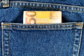 Several bills of fifty euros in the back pocket of jeans. Concept of absentminded person, potential victim of theft. Royalty Free Stock Photo