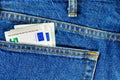 Several bills of five euros in the back pocket of jeans. Concept of absentminded person, potential victim of theft. Royalty Free Stock Photo