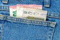 Several bills of five and ten euros in the back pocket of jeans. Concept of absentminded person, potential victim of theft Royalty Free Stock Photo