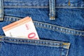 Several bills of ten euros in the back pocket of jeans. Concept of absentminded person, potential victim of theft. Royalty Free Stock Photo