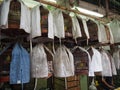 Several bird cages are covered with cloths to shield the birds from external stimuli and