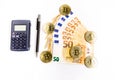 Several bitcoin gold coins next to some euro banknotes, a calculator and a pen Royalty Free Stock Photo