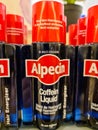 Several black bottles of Alpecin brand hair shampoo with caffeine