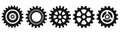 Several black gears casting shadows on a white backdrop Royalty Free Stock Photo
