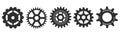 Several black gears casting shadows on a white backdrop Royalty Free Stock Photo