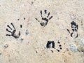 Several Black Handprints on the ground