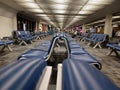 Several blue leather chairs are lined up in the airport. chair without seat.