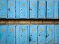 Several blue mailboxes are rowed on a yellow wall Royalty Free Stock Photo