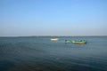 Several blue and yellow boats moored anchored in waters of Jaffna Sri Lanka Royalty Free Stock Photo