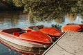 Several boats with oars are moored at the water& x27;s edge at the pier in the city park for water walks on the river Royalty Free Stock Photo