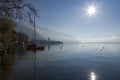 Several boats stand near the shore on Lake Leman