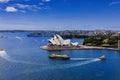 some boats are travaling through a river by the sydney opera Royalty Free Stock Photo