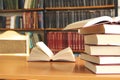 Several books in the table with bookshelf background Royalty Free Stock Photo