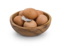 Several brown Eggs in wooden bowl isolated on white background
