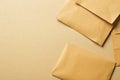 Several brown envelopes scattered casually on a light colored, textured craft paper background. Several Royalty Free Stock Photo