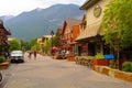 several buildings in the village with bicycles and people walking around