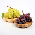 Several bunches of white and red grapes on wooden plates. On a white background. Royalty Free Stock Photo