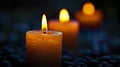 Several candles lit under a night vigil in a dark environment.