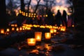Several candles are seen burning brightly on top of a sidewalk, casting a warm glow, A candlelight vigil held at a war memorial to
