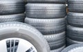 Several car tires are lined up in a tire shop