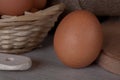 Several chicken eggs. Rustic food. Close up. Brown egg in a basket
