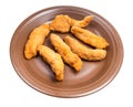 several chicken strips on brown plate isolated