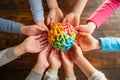 Several children& x27;s hands holding a colored brain illustrating Neuro diversity