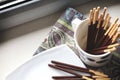 A several chocolate sticks in the cup on the window sill