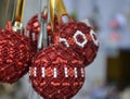 Several Christmas balls of red and white beads.