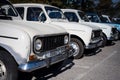 Several classic white Renault 4 cars parked in line