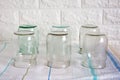 Several clean, empty half-litre glass jars sit upside down on the kitchen table. Time to preserve Royalty Free Stock Photo