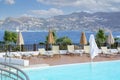 Several closed umbrellas near the pool in Greece. Greek hotel by the sea Royalty Free Stock Photo