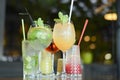 Several cocktails drinks on wooden table at bar in summer time. Summer seasonal alcohol drinks in a bar or restaurant