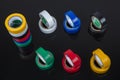 Several coils of colored tape insulating tape on black background. Adhesive tape Electrical tapes on a black background. View