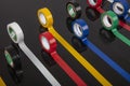 Several coils of colored tape insulating tape on black background. Adhesive tape Electrical tapes on a black background. View