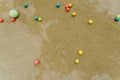 Several colored balls on the green floor of a school, views from above, background with copy space Royalty Free Stock Photo